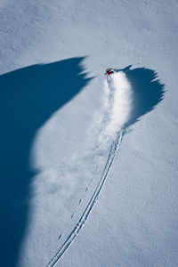Shadow of person skiing on land