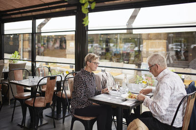 Mature couple having meal in restaurant