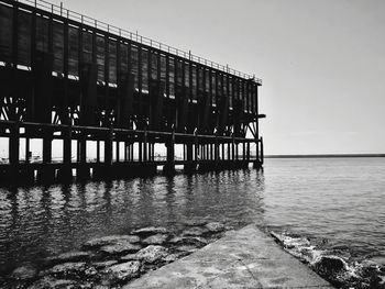 Pier over sea against clear sky