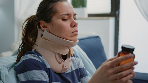 Portrait of young woman using mobile phone