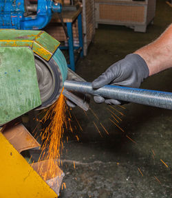 Cropped hand of man working in factory