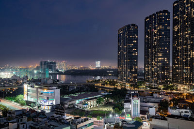 High angle view of illuminated buildings against sky at night