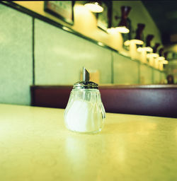 Close-up of glass bottle on table in restaurant