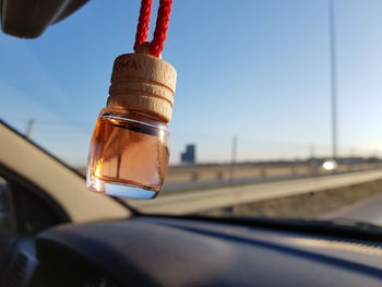 Close-up of light bulb against sky