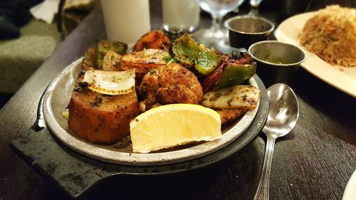 High angle view of roasted food served in container on table