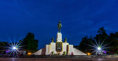 Low angle view of statue against blue sky at night