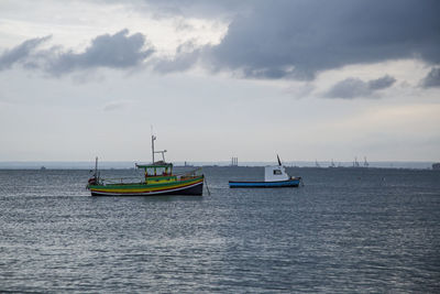 Boat sailing in sea against sky