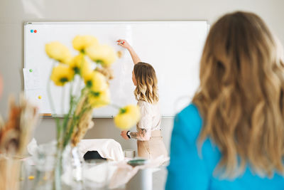 Portrait of woman working on table