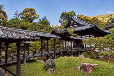 Gazebo by trees against clear sky