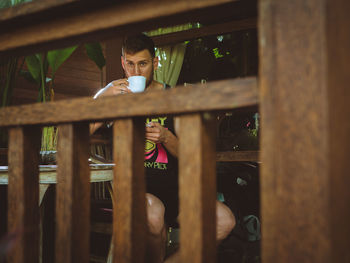 Portrait of young man having drink