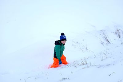 Full length of child on snow covered field