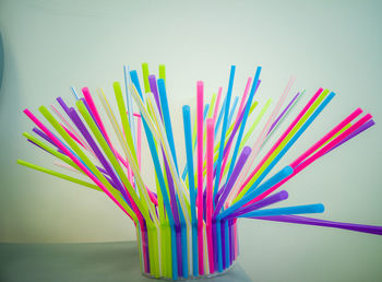 Close-up of colorful drinking straws on table