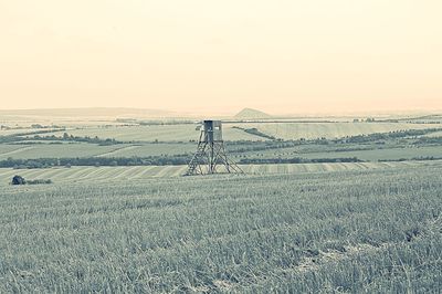 Windmill on field against clear sky