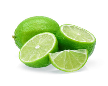 Close-up of green fruit against white background