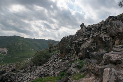 Rock formations on landscape against sky