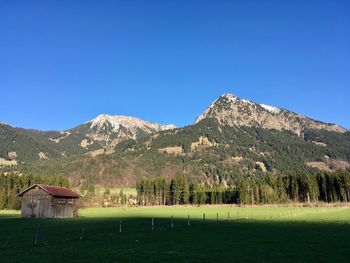 Scenic view of mountains against clear blue sky