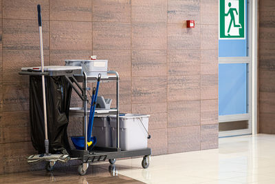 Cleaning equipment on trolley against wall