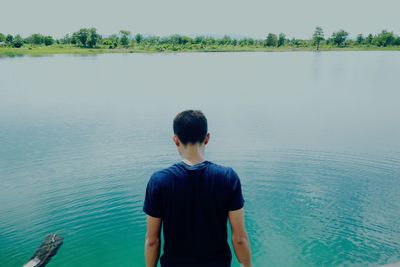 Rear view of man looking at lake
