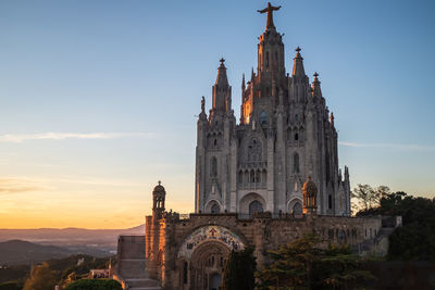 The temple of the sacred heart, located on the top of mount tibidabo in barcelona, spain, at sunset. 