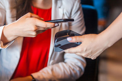 Midsection of man using mobile phone