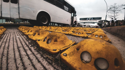 Close-up of yellow car on road