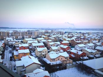 Snow covered residential district against sky