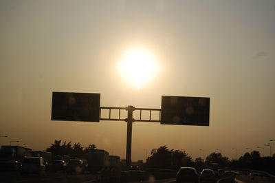Silhouette basketball hoop against sky at sunset