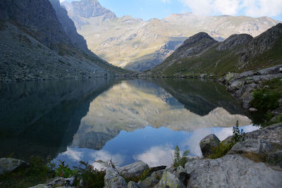 Scenic view of lake and mountains against sky