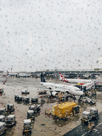 High angle view of airplane on airport runway during rainy season