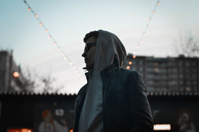 Midsection of man in city against sky