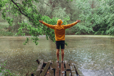 Full length rear view of man standing in lake