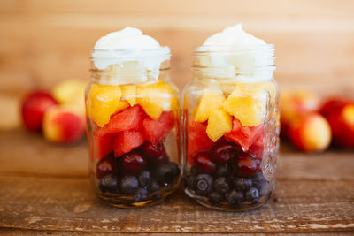 Jars with chopped fruit salad. mango, apple, grapes, blueberries and strawberries, with yogurt. 