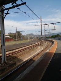 Train at railroad station against sky