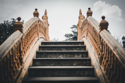 Low angle view of staircase by building against sky