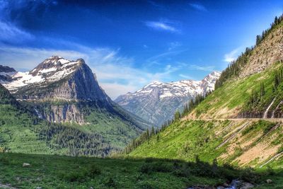 Scenic view of rocky mountains against cloudy sky