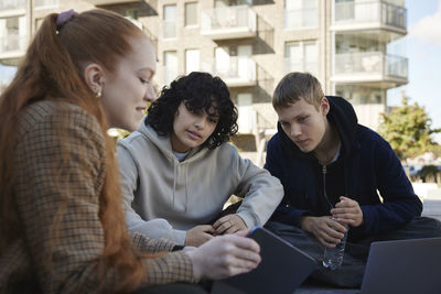 Friends sitting outside together