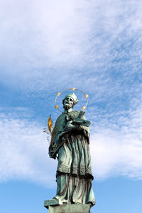 Low angle view of statue against cloudy sky