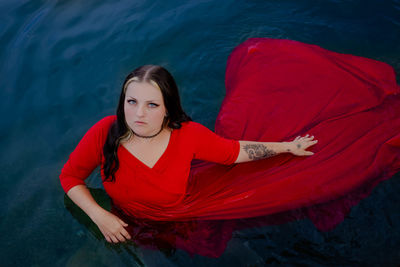 Portrait of smiling young woman in a lake