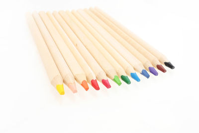 Close-up of colored pencils against white background