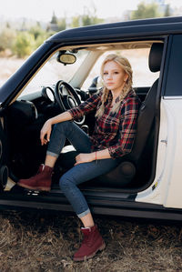 Portrait of woman sitting in car