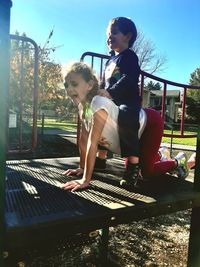 Children playing on bench in park