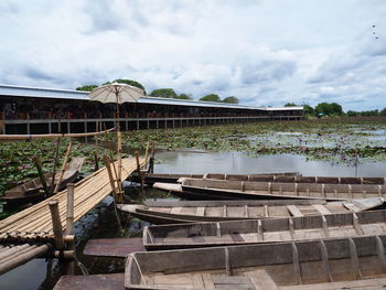 Built structure by river against sky