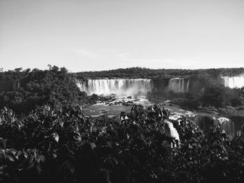 Scenic view of waterfall against clear sky