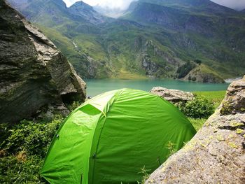 Scenic view of lake against mountains tents 