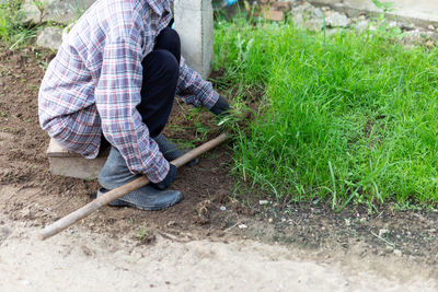 Rear view of man working on field