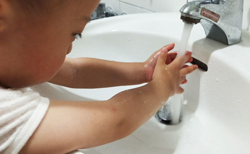 Midsection of woman in bathroom at home