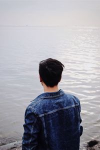 Rear view of man standing in lake