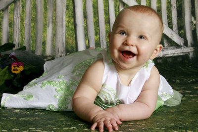 Cute baby girl looking away on land