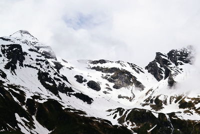 Scenic view of mountains against cloudy sky
