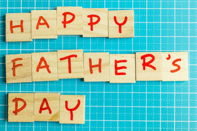 Directly above shot of wooden letter blocks on blue table